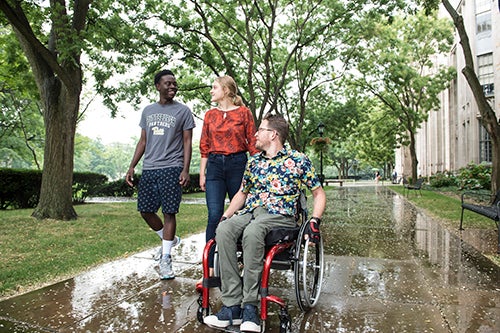 trio of students walking on Pitt campus