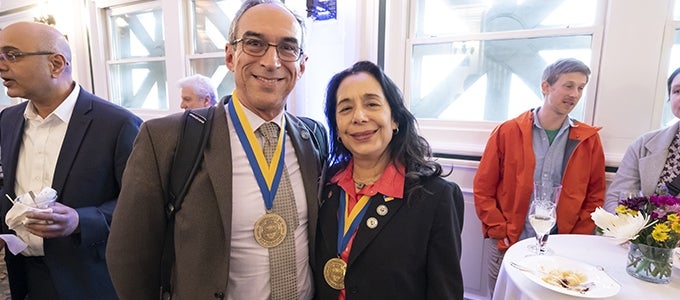 Two distinguished faculty appointees with their medallions
