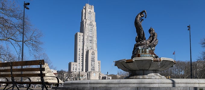 fountain statue with cathedral of learning in background