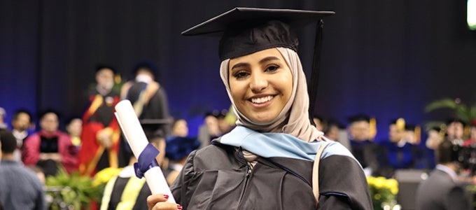 Pitt graduate holding diploma