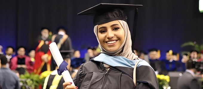 Pitt graduate holding diploma