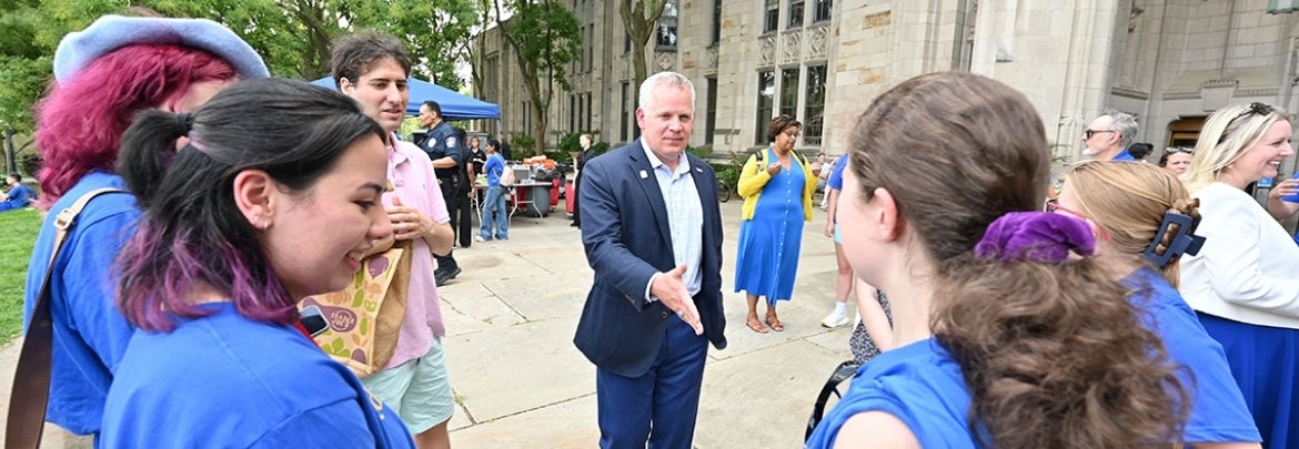 Interim Provost and Senior Vice Chancellor Joseph McCarthy greeting students at Pitt Honors picnic Fall 2023