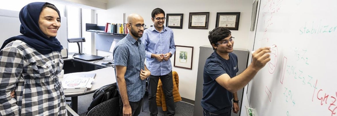 Dr. Kaushik Seshadreesan working with School of Computing and Information students