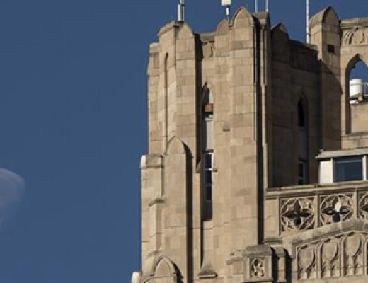 top of Cathedral of Learning with moon showing beside it