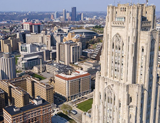 drone's-eye view of Pitt campus with city of Pittsburgh in background