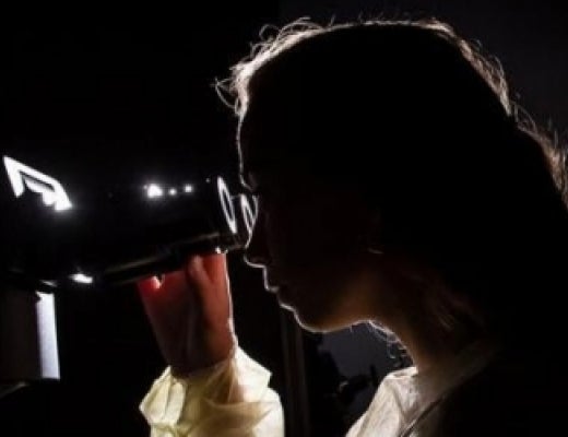 A person looking through a microscope